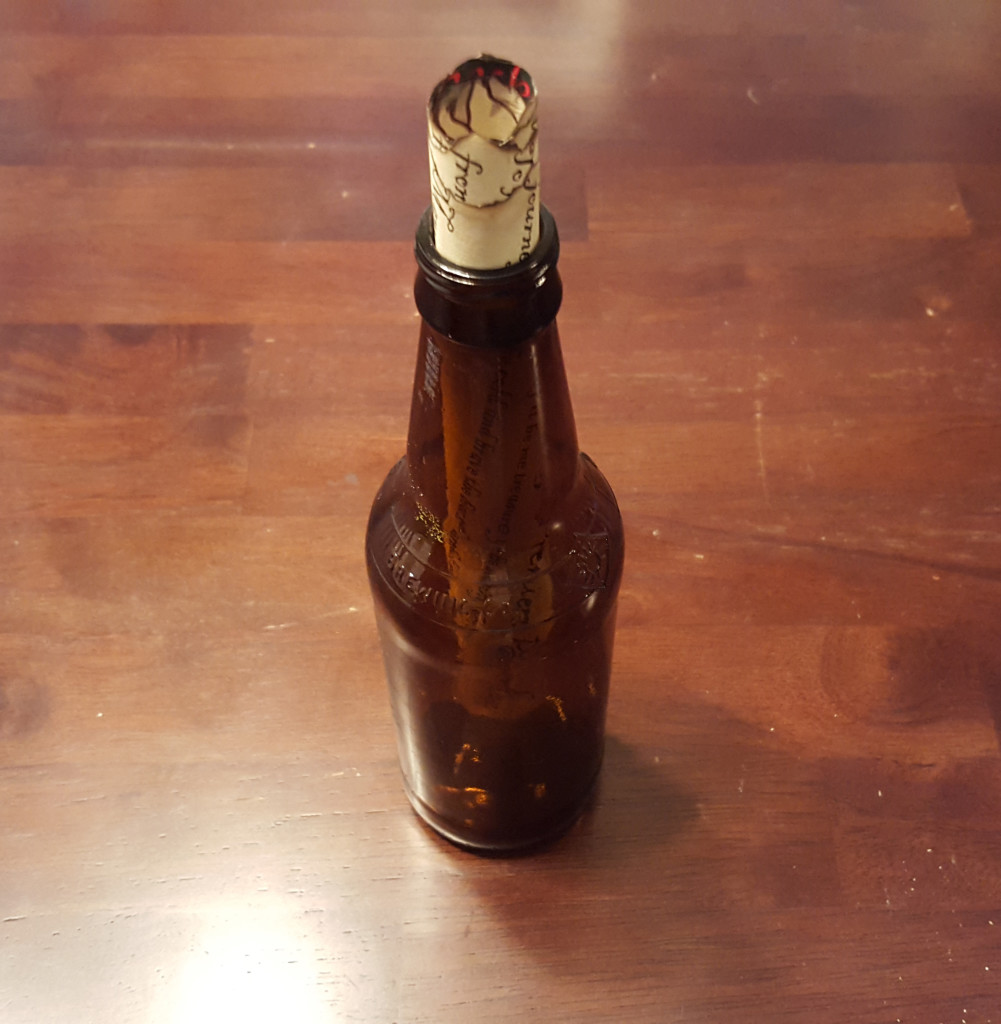 The assembled treasure map in the bottle of grog.